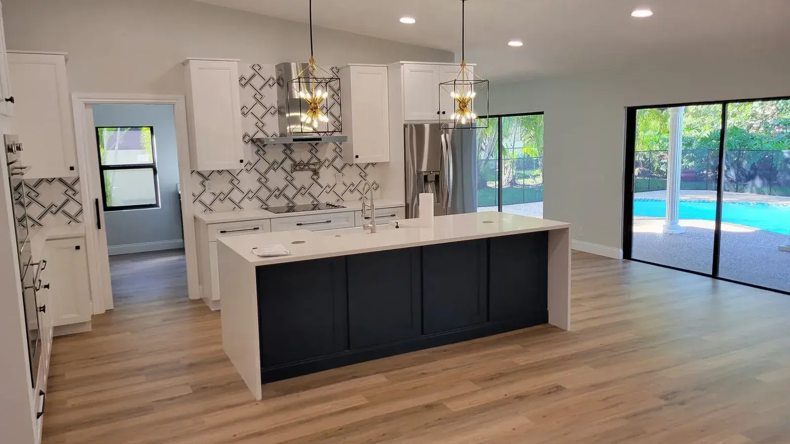 Open plan kitchen and island opening onto the pool deck